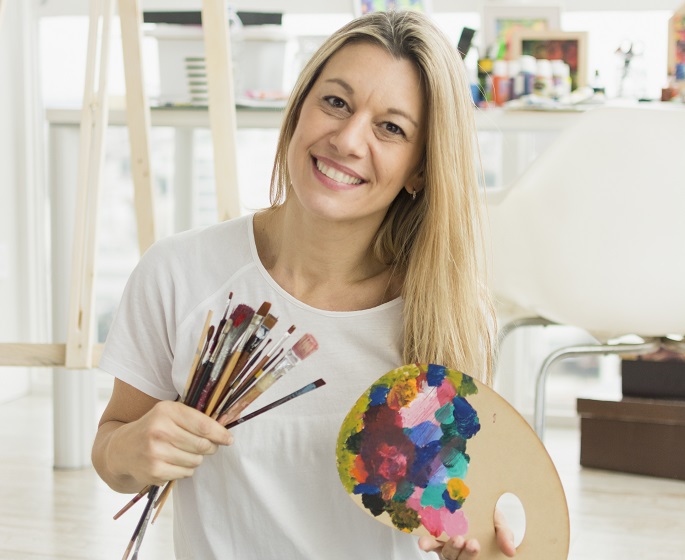 happy woman with art supplies