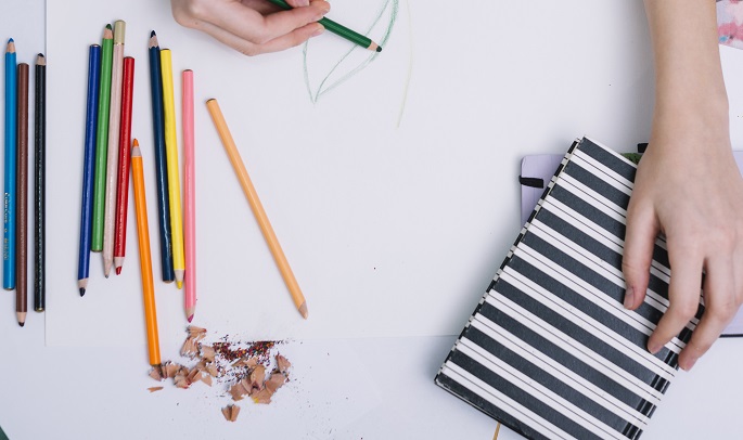 person using colour pencil for drawing